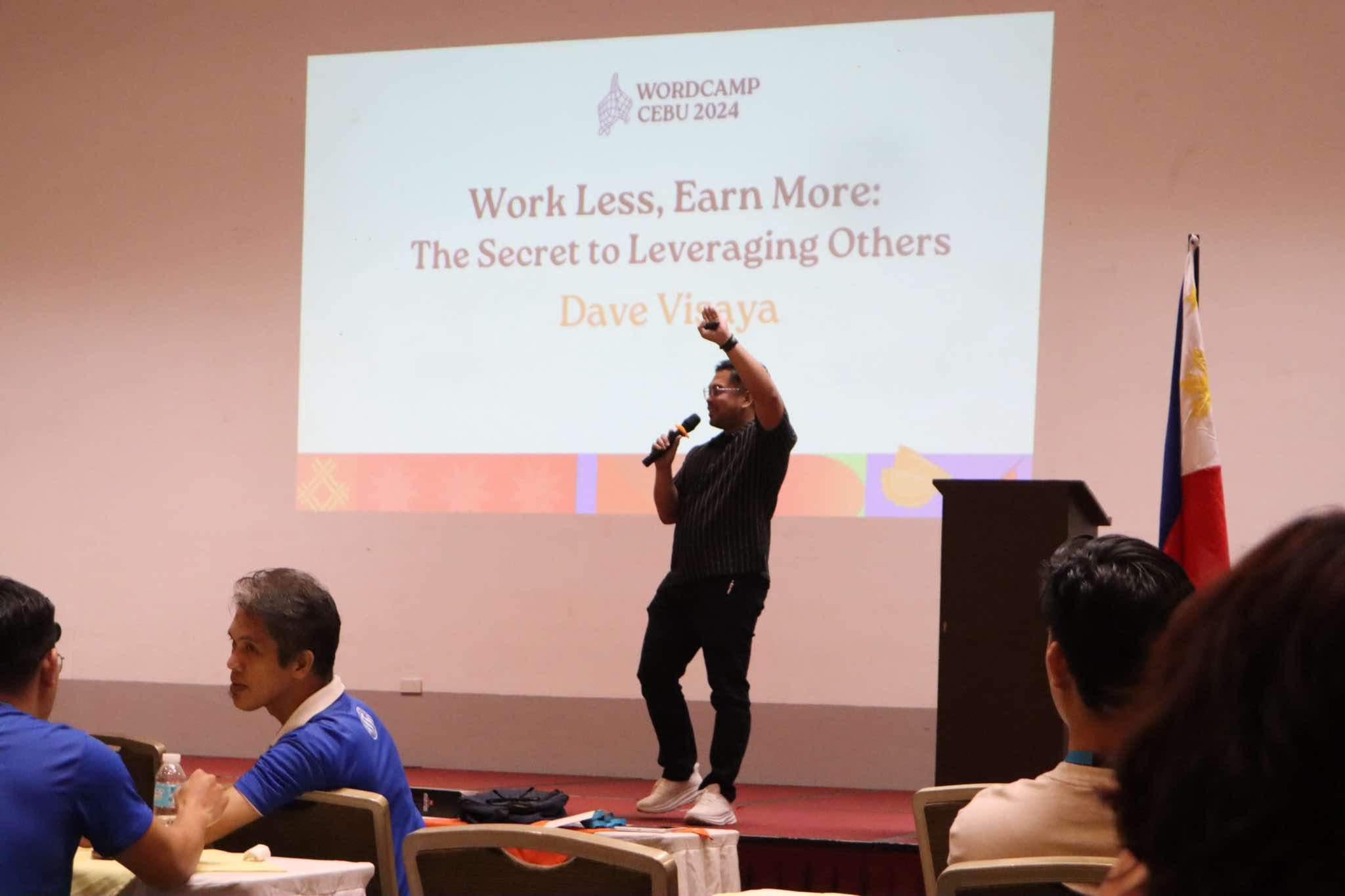 Dave Visaya hosting on stage at a Toastmasters contest