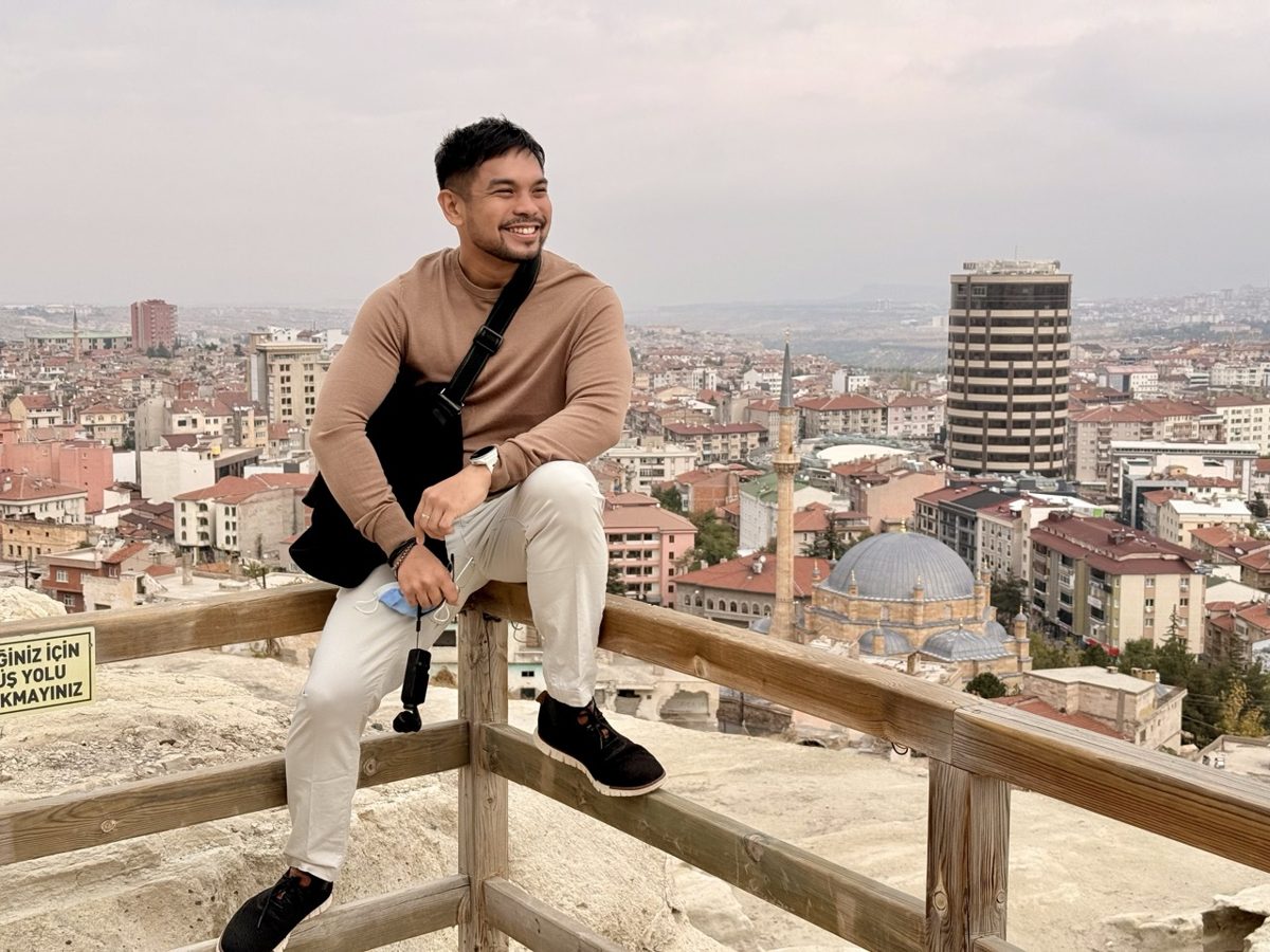Overlooking the city from a rooftop railing